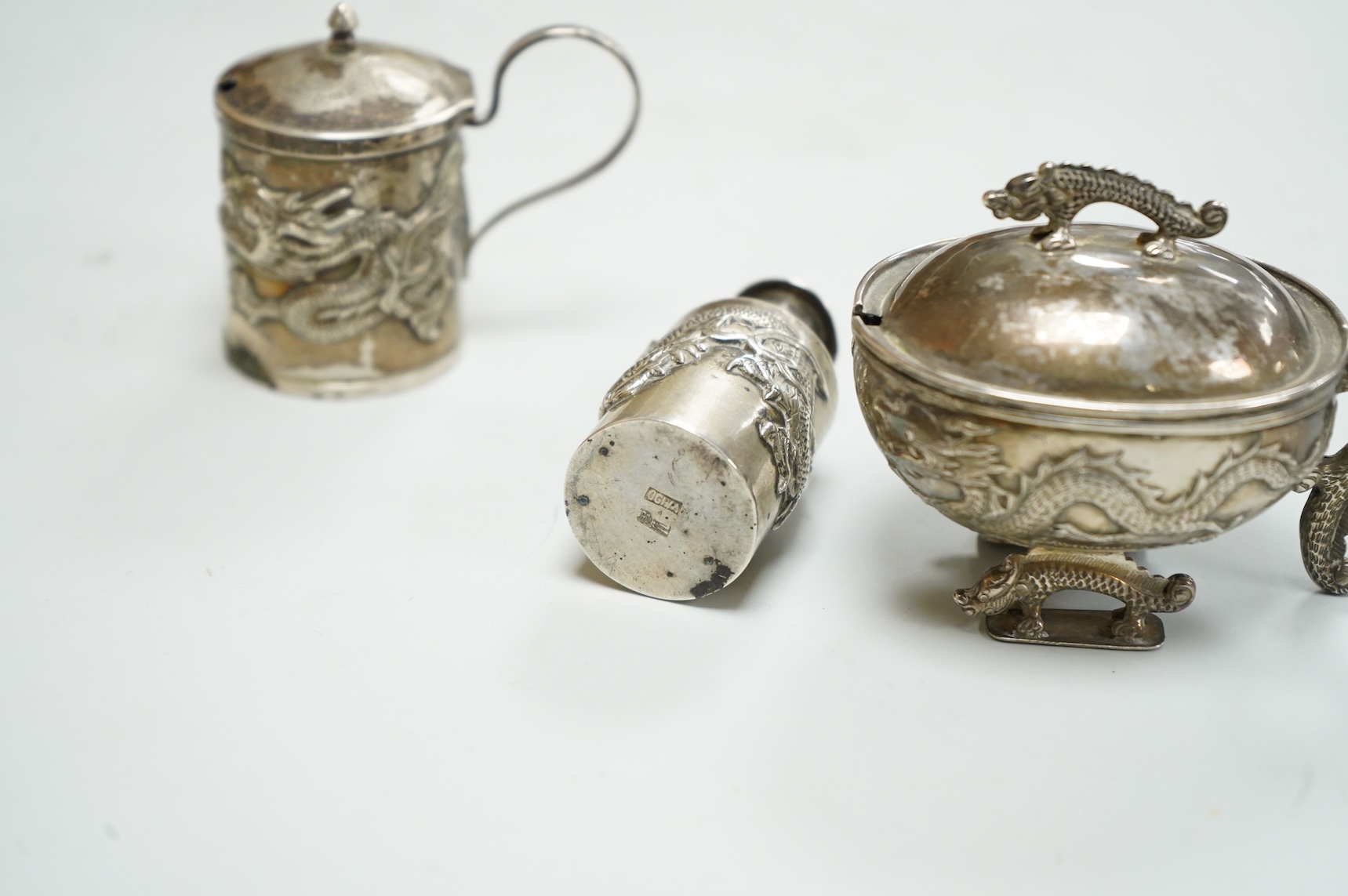 Three early 20th century Chinese export white metal condiments including a drum mustard pot and pepperette by Wang Hing, Hong Kong, pepperette 63mm.